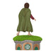 Statue of a character in a green cloak standing on a small building with grass roof