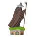 Statue of a wizard in a brown robe with a staff on a green platform