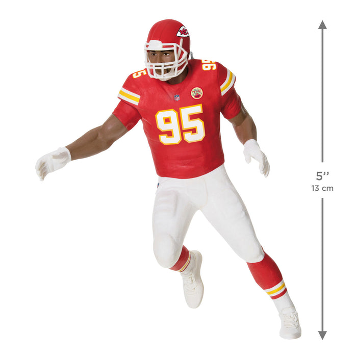 Football player figure in red and white uniform with number 95, standing on a white background.