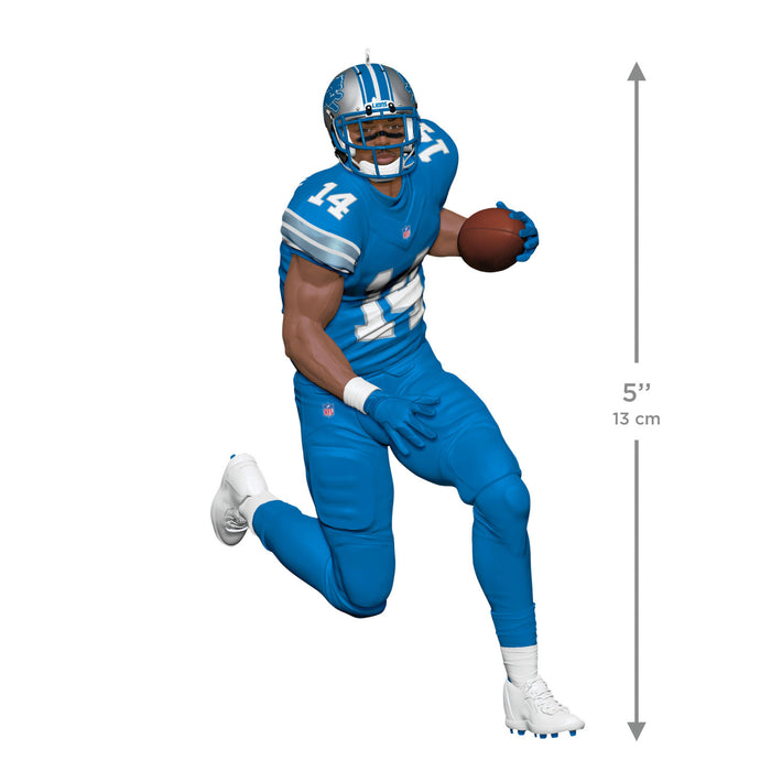 Football player in blue uniform with number 14 holding a ball on a white background