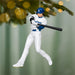 Baseball player ornament with bat hanging from a tree