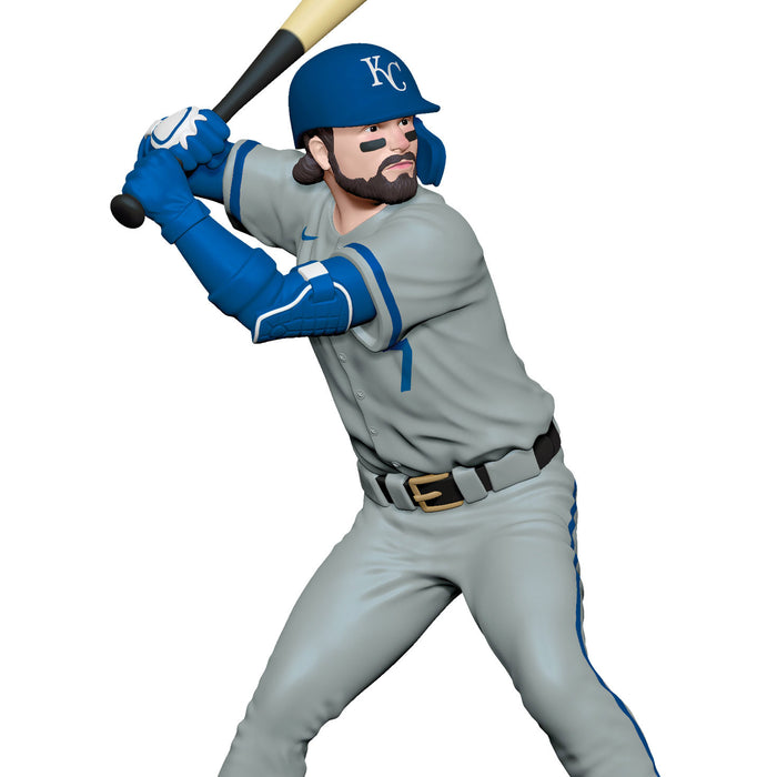 Baseball player figurine in gray and blue uniform with bat on white background