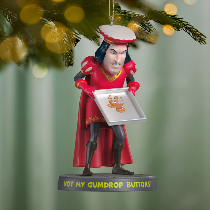 Ornament of a character in a red outfit holding a tray with 'Not My Gumdrop Buttons!' text, hanging on a Christmas tree.