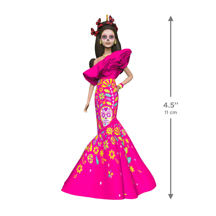 Barbie doll in a colorful dress with sugar skull design, standing next to a height measurement indicator.