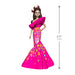 Barbie doll in a colorful dress with sugar skull design, standing next to a height measurement indicator.