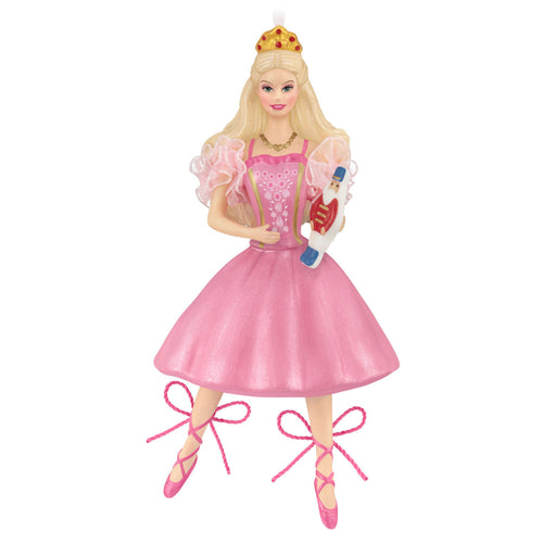 Barbie doll in a pink dress with a crown and ballet shoes on a white background