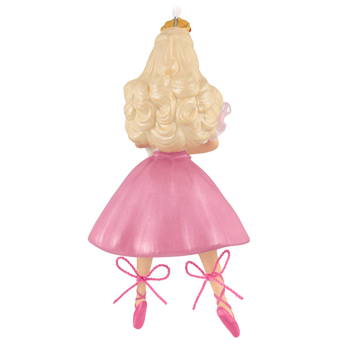 Decorative ornament of a ballerina with blonde hair, pink dress, and shoes on a white background