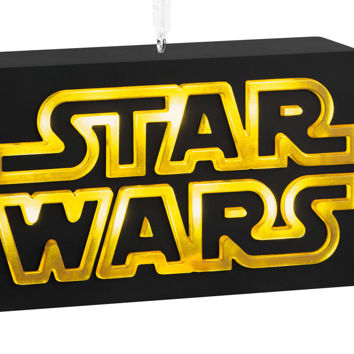 Star Wars logo in gold and black on a black background