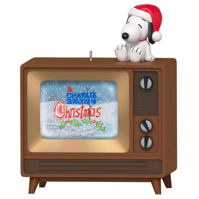 Snoopy in a Santa hat on top of a vintage TV showing 'A Charlie Brown Christmas'.
