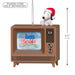 Decorative ornament of a dog in a Santa hat on an old-fashioned TV with 'A Charlie Brown Christmas' on screen, with text indicating power cord sold separately.