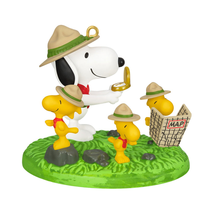 Snoopy and Woodstock figurine on a green base with a white background