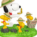 Snoopy and Woodstock figurines in a camping scene with a map.