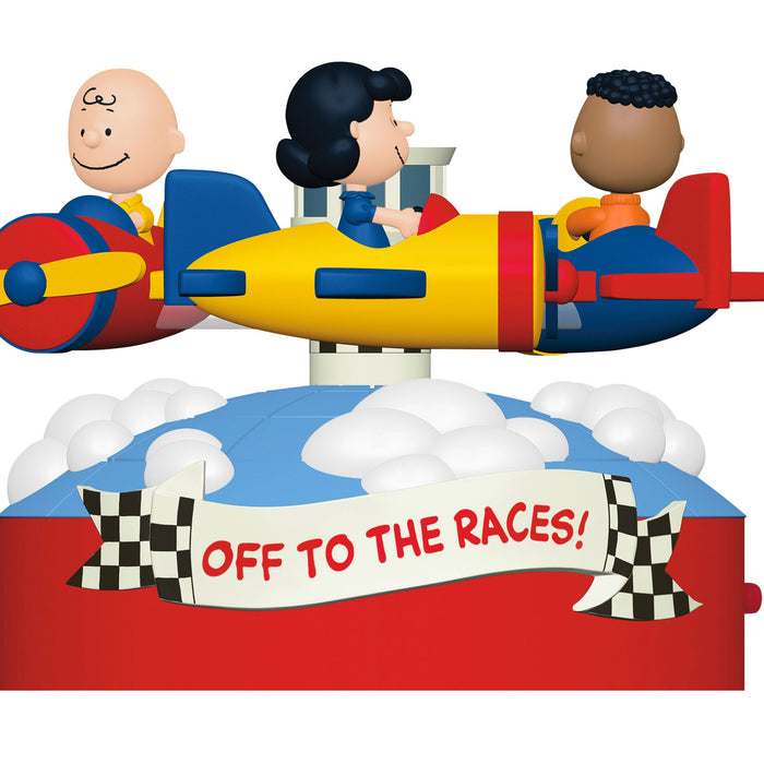 Toy set with three characters in a race car with 'Off to the Races!' banner, on a white background
