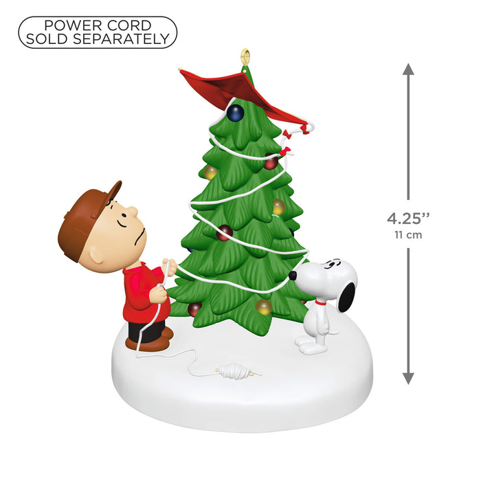 Christmas-themed figurine with a tree, boy, and dog on a white background