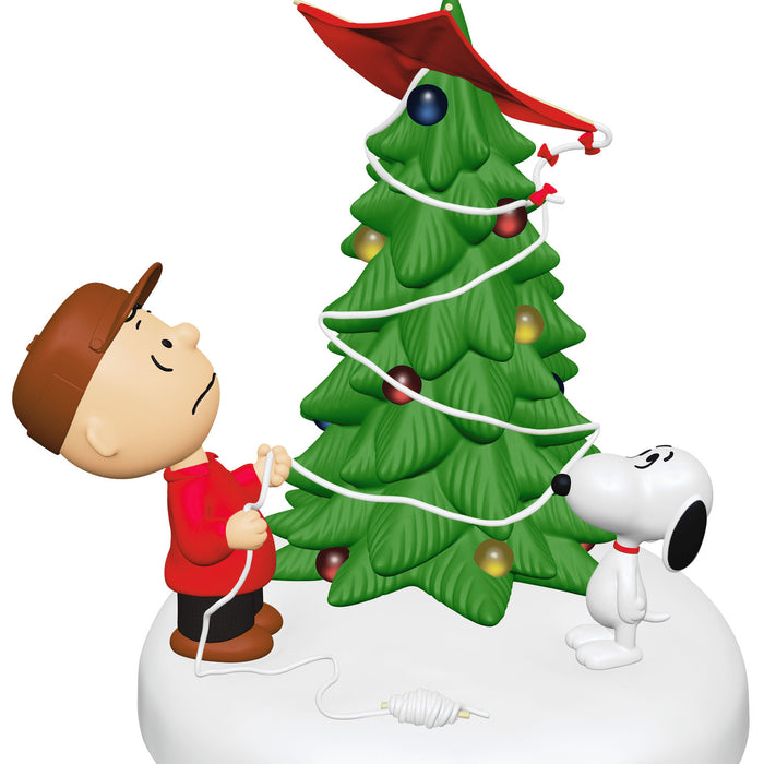 Christmas-themed figurine with a boy, tree, and dog on a white background