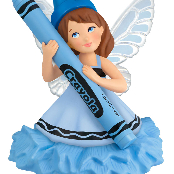 Crayon fairy holding a blue Crayola crayon on a white background
