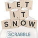 Scrabble tiles spelling 'LET IT SNOW' with snow on top, featuring the Scrabble logo.