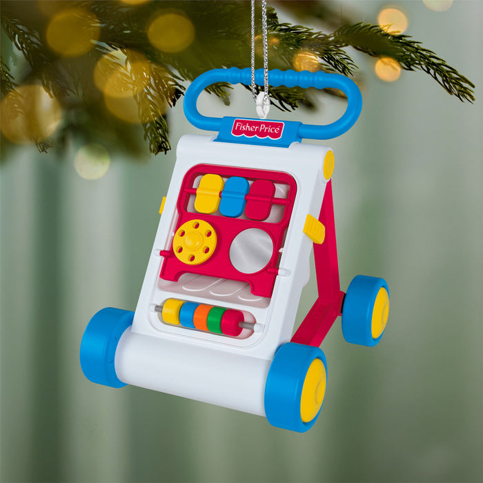 Fisher-Price toy walker ornament hanging on a Christmas tree.