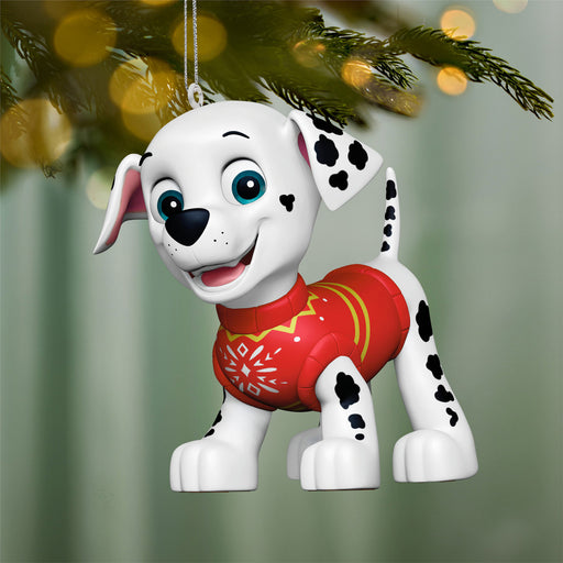 Christmas ornament of a dalmatian dog in a red sweater hanging on a tree.