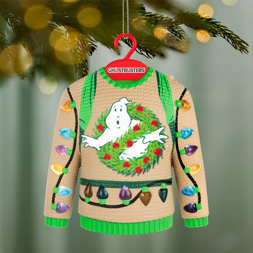 Ghostbusters sweater ornament with a ghost and wreath design, hanging on a Christmas tree.