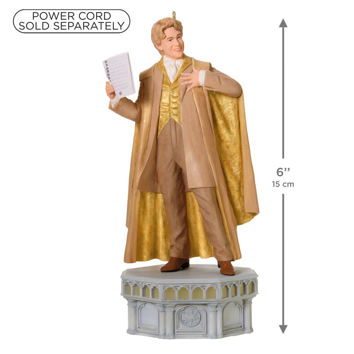 Statue of a man in a gold and beige outfit with a power cord sold separately label.