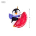 Penguin ornament with a red glittery candy on a white background