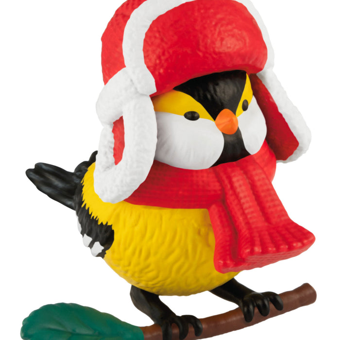 Toy bird figurine wearing a red hat and scarf on a white background