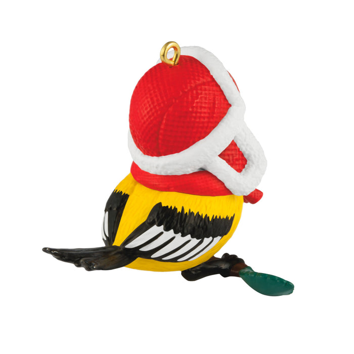 Decorative Christmas ornament shaped like a bird wearing a Santa hat on a white background