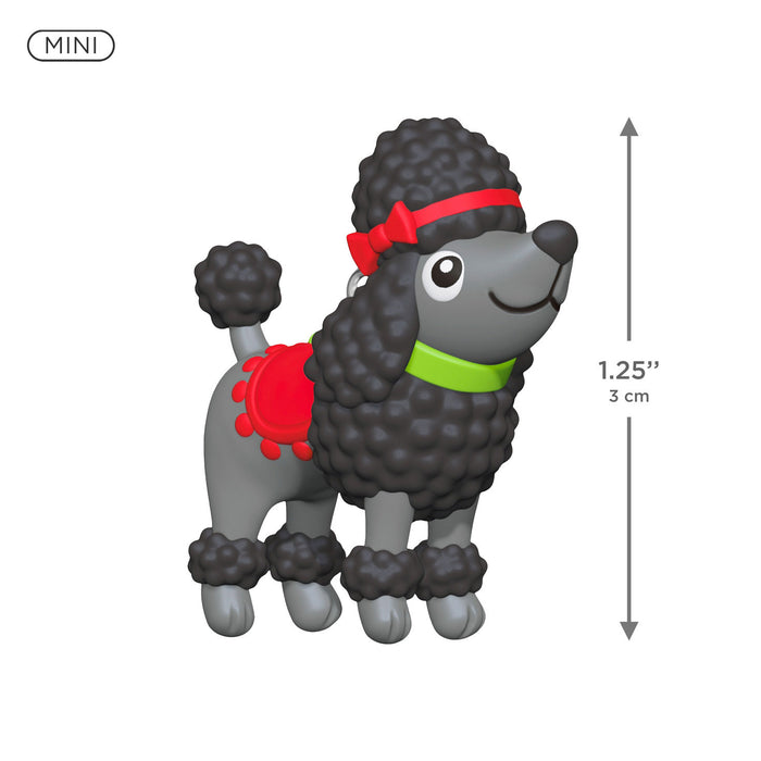 Miniature poodle figurine with a red bow and green collar, showing size measurement on a white background.