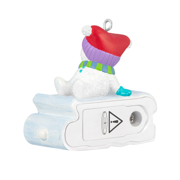 Decorative pencil sharpener with a snowman design on a white background