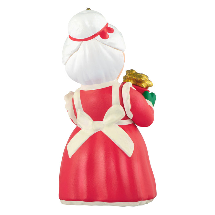 Figurine of a character in a red dress with a white apron holding a bouquet on a white background