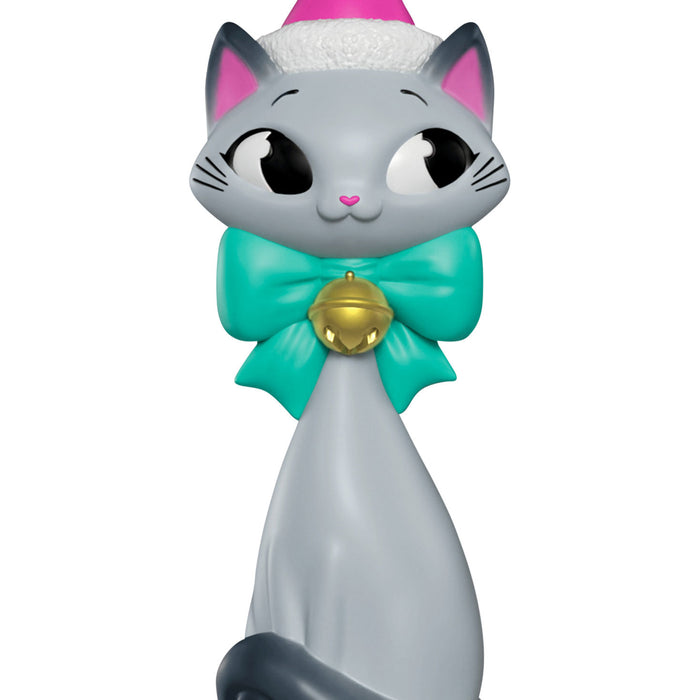 Cat-shaped figurine with a green bow and gold bell on a white background