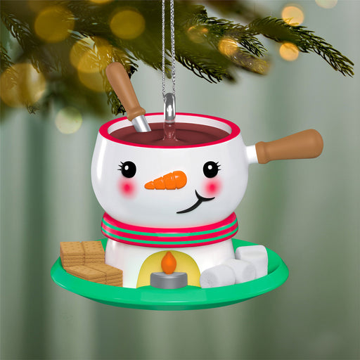 Snowman-themed fondue pot ornament with a candle on a Christmas tree.