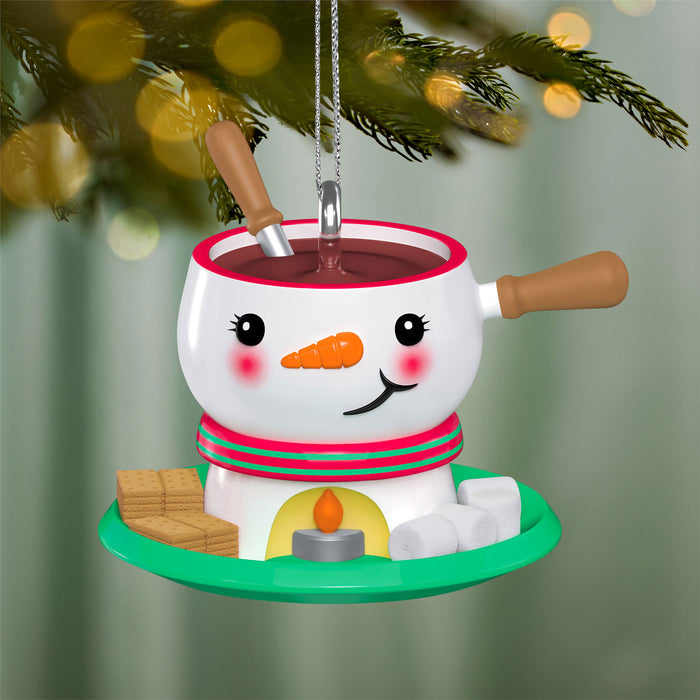 Snowman-themed fondue pot ornament with a candle on a Christmas tree.