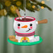 Snowman-themed fondue pot ornament with a candle on a Christmas tree.