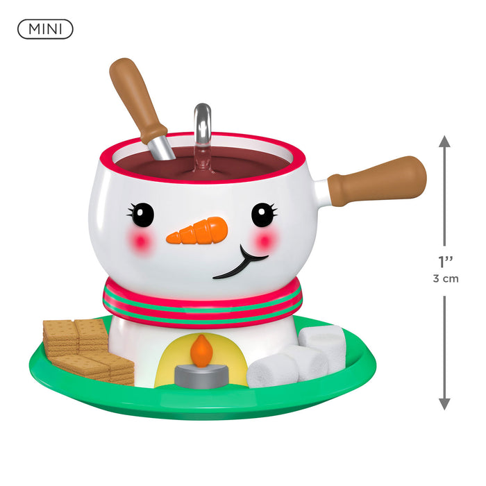 Snowman-themed hot chocolate set with a mini fondue pot on a white background