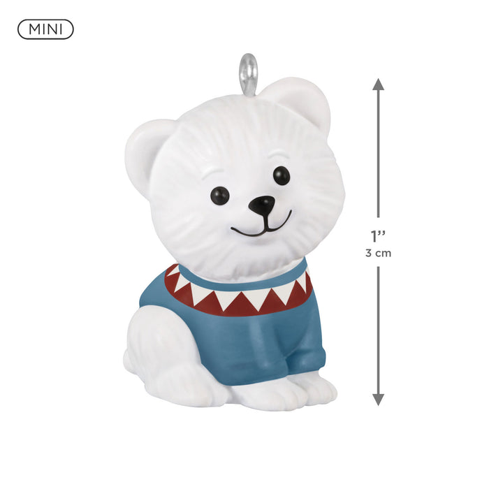 White polar bear figurine with a blue sweater and red trim, featuring measurements on a white background.