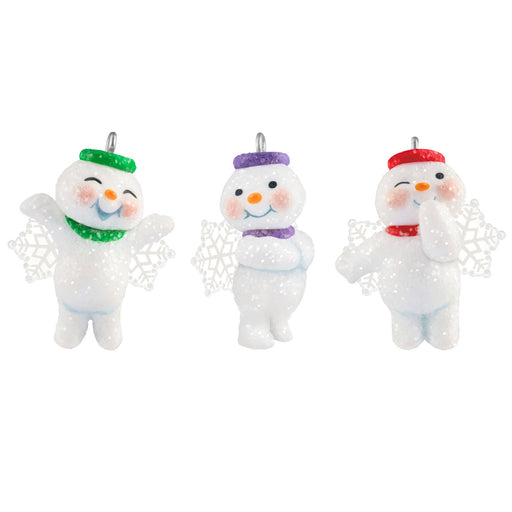 Three snowman ornaments with colorful hats on a white background