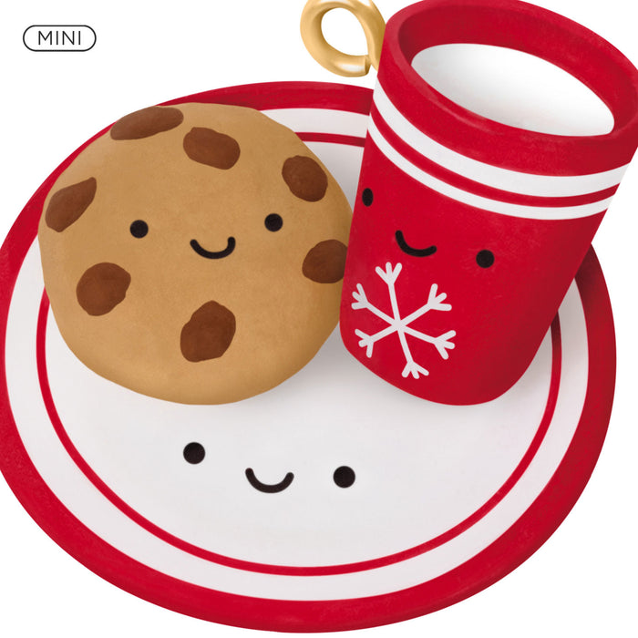 Miniature cookie and mug set with faces on a white background