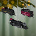 Three Pennsylvania Railroad train ornaments hanging on a Christmas tree.