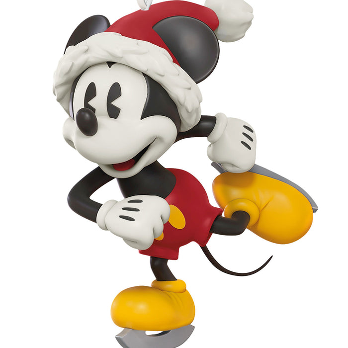 Mickey Mouse figurine wearing a Santa hat on a white background