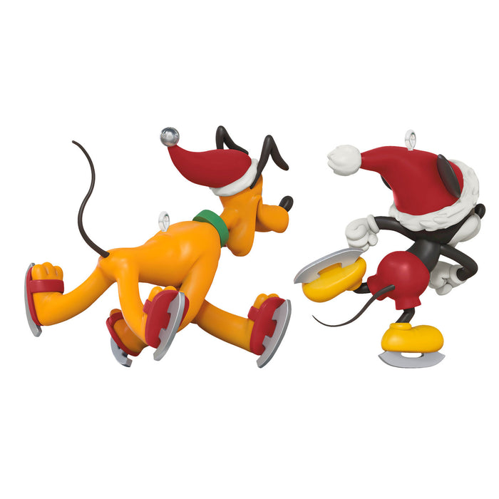 Two cartoon character figurines on ice skates with Santa hats on a white background