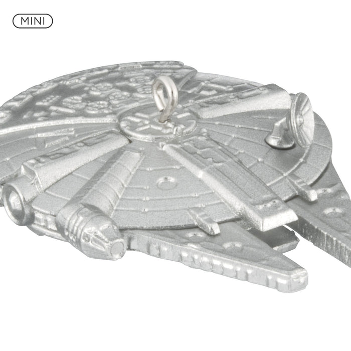 Metallic model of a spaceship with 'MINI' label on a white background
