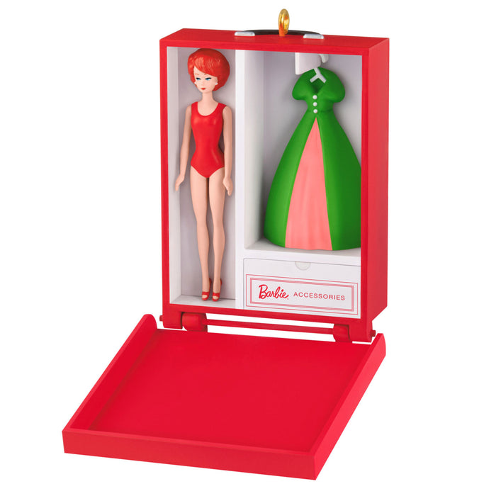 Barbie doll with red hair and a green dress in a red box on a white background