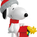 Snoopy figurine with a red hat and scarf, holding a small red house with Woodstock on top.