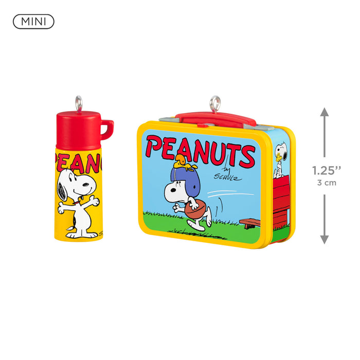 Peanuts-themed lunch box and thermos with cartoon characters on a white background