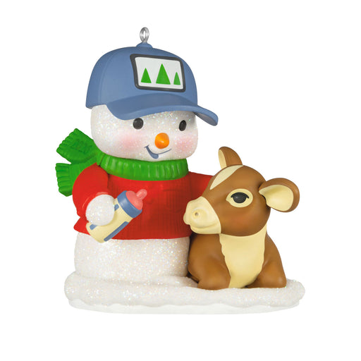 Christmas ornament featuring a snowman with a baby bottle and a calf on a white background