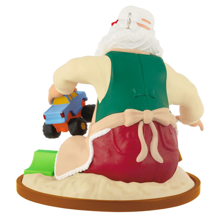 Figurine of a character with a large red sack, driving a toy car, on a white background