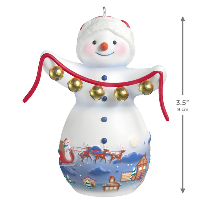 Decorative snowman ornament with bells and Santa Claus scene, featuring dimensions on a white background.
