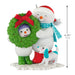 Decorative Christmas ornament featuring two snowmen with a dog and a wreath, with a measurement indicator.